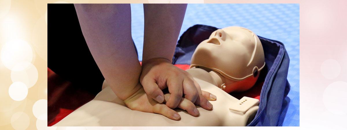 Hands atop a Cardiopulmonary Resuscitation (CPR) mannequin
